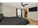 Bedroom featuring wood floors, a ceiling fan, TV, and a closet at 7041 Lexington Cir, Brooksville, FL 34602