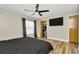 Bedroom featuring wood floors, a ceiling fan, TV, and a door to the closet at 7041 Lexington Cir, Brooksville, FL 34602
