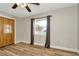 Bright bedroom with closet and updated ceiling fan fixture at 7041 Lexington Cir, Brooksville, FL 34602
