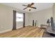 Light and airy bedroom with a ceiling fan and wood-look flooring at 7041 Lexington Cir, Brooksville, FL 34602
