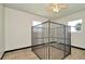 Bonus room with wood floors, windows, and unique, metal constructed enclosure in the center at 7041 Lexington Cir, Brooksville, FL 34602