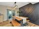 Stylish dining area featuring a rustic wooden table, an accent wall, and view to outdoor patio at 7041 Lexington Cir, Brooksville, FL 34602