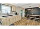 Bright kitchen with modern countertops adjoins dining area with a rustic table, and chic accent wall at 7041 Lexington Cir, Brooksville, FL 34602
