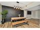 Dining area features a wooden table with bench seating, modern lighting, and a unique accent wall at 7041 Lexington Cir, Brooksville, FL 34602