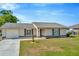 Charming single-story home featuring a well-maintained lawn, attached garage, and neutral color palette at 7041 Lexington Cir, Brooksville, FL 34602