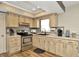 Well-lit kitchen featuring stainless steel appliances, light wood cabinetry, and ample countertop space at 7041 Lexington Cir, Brooksville, FL 34602