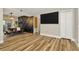 Open living space with a large flatscreen TV and wood-look floors at 7041 Lexington Cir, Brooksville, FL 34602