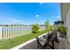 Inviting backyard featuring a cozy seating area, manicured lawn, and scenic views of the waterfront at 8580 Ivy Stark Blvd, Wesley Chapel, FL 33545
