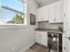 Wet bar featuring white cabinets, granite countertops, and a convenient wine cooler at 8580 Ivy Stark Blvd, Wesley Chapel, FL 33545