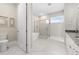 Bright bathroom featuring a freestanding tub, glass enclosed shower, and double sink vanity at 8580 Ivy Stark Blvd, Wesley Chapel, FL 33545