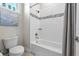 Well-lit bathroom featuring tub-shower combination and white subway tile and mosaic accents at 8580 Ivy Stark Blvd, Wesley Chapel, FL 33545