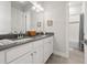 Well-lit bathroom with double vanity, white cabinets, and a shower-tub combo at 8580 Ivy Stark Blvd, Wesley Chapel, FL 33545