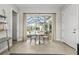 Dining area with views of the screened pool and patio through sliding glass doors at 8580 Ivy Stark Blvd, Wesley Chapel, FL 33545