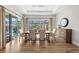 Dining room with lots of natural light, view of screened in pool and access to patio at 8580 Ivy Stark Blvd, Wesley Chapel, FL 33545