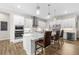 Beautiful kitchen with stainless appliances, island with bar seating, and modern lighting at 8580 Ivy Stark Blvd, Wesley Chapel, FL 33545