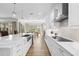 Modern kitchen with island, sink, stainless steel appliances and hardwood floors at 8580 Ivy Stark Blvd, Wesley Chapel, FL 33545