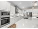 Bright, modern kitchen with stainless steel appliances, white cabinets, and sleek countertops at 8580 Ivy Stark Blvd, Wesley Chapel, FL 33545