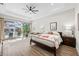 Main bedroom with pool access, ceiling fan and a sitting area at 8580 Ivy Stark Blvd, Wesley Chapel, FL 33545