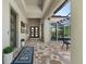 Inviting outdoor patio area with brick pavers, leading to a screened-in pool at 8580 Ivy Stark Blvd, Wesley Chapel, FL 33545