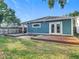 Exterior shot of the back of the home featuring a wood deck and backyard at 917 W Alfred St, Tampa, FL 33603
