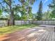 Well maintained backyard with wooden deck, grassy area, and privacy fence at 917 W Alfred St, Tampa, FL 33603