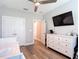 Bedroom featuring a dresser, TV, closet, and a doorway leading to another room at 917 W Alfred St, Tampa, FL 33603