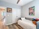 Bright bedroom featuring a plush bed, framed artwork, and a doorway leading to another room at 917 W Alfred St, Tampa, FL 33603