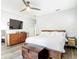 Spacious bedroom featuring modern decor, wood floors, a ceiling fan, and a large window for plenty of natural light at 917 W Alfred St, Tampa, FL 33603
