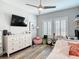Bright bedroom featuring a ceiling fan, dresser, and windows with plantation shutters at 917 W Alfred St, Tampa, FL 33603