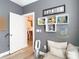 Cozy room featuring modern gray walls and shelving, complemented by an open doorway to the kitchen at 917 W Alfred St, Tampa, FL 33603