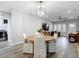 Bright dining room featuring modern lighting and a view into the open living space with wood floors at 917 W Alfred St, Tampa, FL 33603