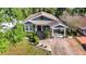 Charming two-story home with landscaped yard, covered porch, and brick-paved driveway at 917 W Alfred St, Tampa, FL 33603