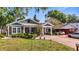 Charming home with landscaped front yard, covered porch, and convenient carport at 917 W Alfred St, Tampa, FL 33603