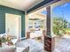 Inviting front porch with seating area overlooking manicured landscape and carport at 917 W Alfred St, Tampa, FL 33603
