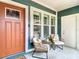 Charming covered front porch with seating area and stylish front door at 917 W Alfred St, Tampa, FL 33603