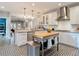 Stylish kitchen with white cabinets, stainless steel appliances, and a view of adjacent living spaces at 917 W Alfred St, Tampa, FL 33603