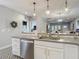 Bright kitchen featuring white cabinets, stainless steel appliances, and a stylish tile floor at 917 W Alfred St, Tampa, FL 33603