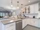 Charming kitchen with white cabinets, stainless steel appliances, and stylish patterned tile flooring at 917 W Alfred St, Tampa, FL 33603