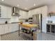 Modern kitchen with white cabinetry, stainless steel appliances, and patterned floors at 917 W Alfred St, Tampa, FL 33603
