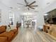 Open-concept living space featuring a large sectional sofa, stylish lighting, and hardwood flooring at 917 W Alfred St, Tampa, FL 33603