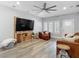 Bright living room showcasing wood floors, a large television, and ample space for seating and relaxation at 917 W Alfred St, Tampa, FL 33603