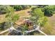 Aerial view of the park playground area with swings and slides surrounded by mature trees and sidewalks at 917 W Alfred St, Tampa, FL 33603