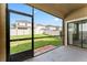 A screened-in back porch overlooks a well-manicured backyard and fences that provide privacy at 935 Terra Vista St, Brandon, FL 33511