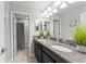 The bathroom features dual sinks, granite countertops, and a shower with a gray curtain at 935 Terra Vista St, Brandon, FL 33511