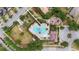 Aerial view of the community pool with lounge chairs, a playground and manicured landscaping at 935 Terra Vista St, Brandon, FL 33511