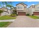 Charming two-story home featuring a brick driveway, attached garage and well-manicured lawn at 935 Terra Vista St, Brandon, FL 33511