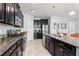 Well-equipped kitchen featuring stainless appliances, dark cabinets, and granite countertops with ample counter space at 935 Terra Vista St, Brandon, FL 33511