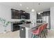 Beautiful kitchen featuring dark cabinets, stainless steel appliances and a large granite island with seating at 935 Terra Vista St, Brandon, FL 33511