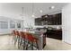 Kitchen boasts an island with bar seating, dark cabinetry, and pendant lighting at 935 Terra Vista St, Brandon, FL 33511