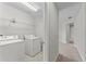 The laundry room features a white washer and dryer along with wire shelving at 935 Terra Vista St, Brandon, FL 33511